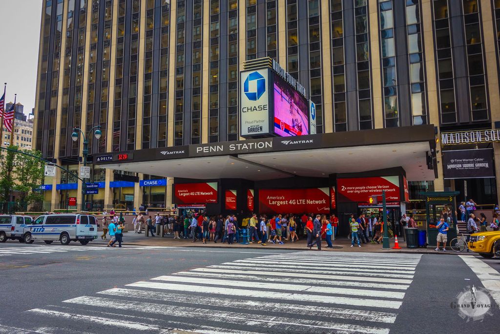 L'entrée de Penn Station, gare principale de New York, entièrement souterraine. Derrière se trouve le Madison Square Garden. L'entrée de Penn Station, gare principale de New York, entièrement souterraine. Derrière se trouve le Madison Square Garden.